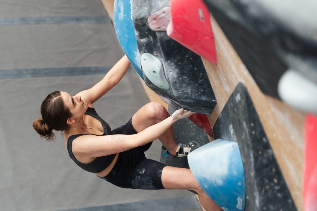 Kobieta wspinająca się na ściance wspinaczkowej